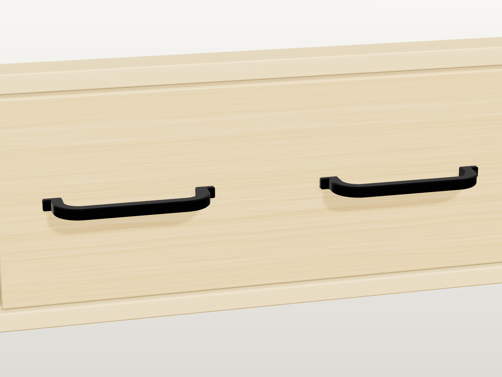 Zwei FabParts Bügelgriffe in Charcoal mit 128 mm Lochabstand an einer Schubladenfront